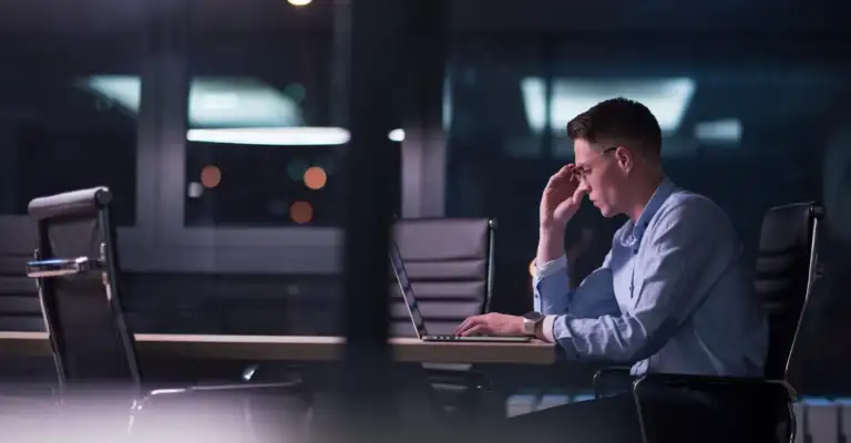 Stressed executive experiencing burnout in a corporate environment needing executive detox recovery