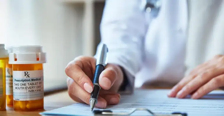 Doctor writing a prescription on a clipboard, representing prescription drug use and medical treatment