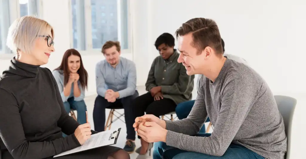 Group therapy session in a rehab center in Dubai with a counsellor supporting patients